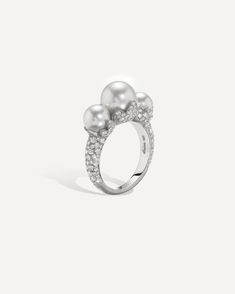 From Irene Neuwirth's Pearl Blossom Collection, this 18k white gold ring is set with a lustrous assortment of Akoya pearls, adorned with diamond pavé encrusted petals and a diamond pavé band. 18k white gold Akoya pearls Brilliant cut diamonds total 1.45 carats Size 7. Please inquire about sizing options. Elegant White Ring For Evening Occasions, Elegant White Ring For Evening, Elegant White Evening Ring, Luxury Pearl Rings With Diamond Accents, Luxury Brilliant Cut Pearl Ring, White Gold Pearl Ring With Pave Diamond Setting, White Gold Pearl Ring With Diamond Pave Setting, Luxury Pearl Ring For Evening, Exquisite Pearl Ring With Brilliant Cut