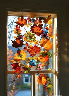 a window with autumn leaves hanging from it