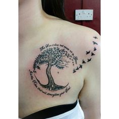 a woman with a tree and birds tattoo on her chest, which reads the lord is always there