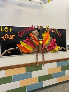 a bulletin board decorated with paper leaves