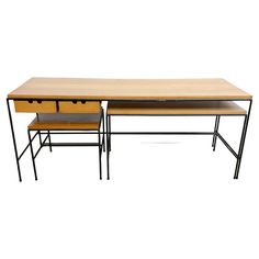 two wooden desks sitting next to each other on top of a white surface with black metal legs