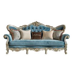 a blue couch with pillows on top of it and some gold trimming around the edges