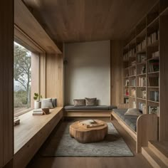 a living room filled with furniture and bookshelves next to a large window covered in wood