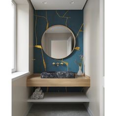 a bathroom with a mirror, sink and towel rack on the wall next to it