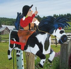 a statue of a man riding on the back of a black and white horse