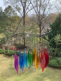 a wind chime hanging from a chain in a garden