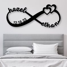 a bed with two hearts and the word love is in black on top of it