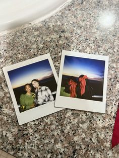 two polaroid pictures sitting on top of a counter