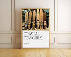 there is a poster on the floor with surfboards in front of it that says coastal cowgirls