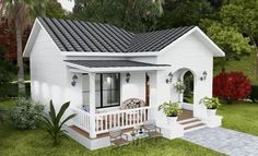 a small white house sitting on top of a lush green field