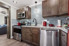 a kitchen with stainless steel appliances and wooden cabinets