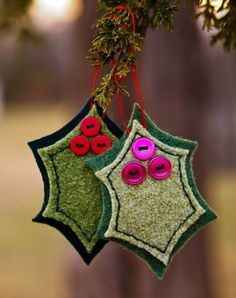 two christmas ornaments hanging from a tree