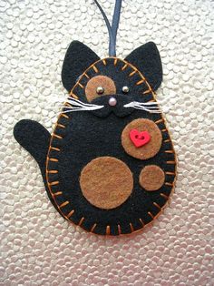 a black cat ornament hanging on a wall