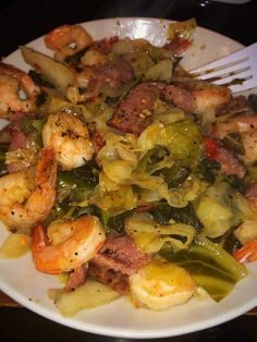 a white plate topped with shrimp and veggies