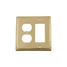 an outlet cover with two outlets in the middle and one on the other side, gold