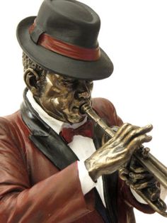 a statue of a man in a top hat and suit holding a trumpet with both hands