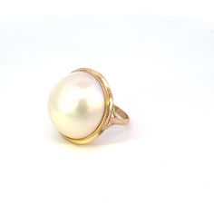 This vintage pearl ring is a perfect statement piece for your private jewelry collection. Bezel set in 14K yellow gold, this 19.25mm pearl is luxurious and glamorous. The delicate 2mm shank has detailed scroll work on the under gallery for added interest. Weight is 4.8Dwt / 7.5 grams. Currently a size 5 US, this ring can easily be sized up or down after purchase. Metal: 14 Karat Vintage yellow gold  Stones: 19.25mm pearl  Weight: 4.8 Dwt/ 7.5 grams  Size: 5 US/ J 1/2 UK Luxury Delicate Yellow Gold Pearl Ring, Vintage Pearl Ring, Pearl Rings Vintage, J 1, Uk Style, Gold Pearl Ring, Scroll Work, Vintage Pearl, Vintage Pearls