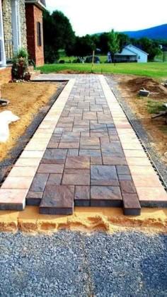 a brick walkway being built in front of a house