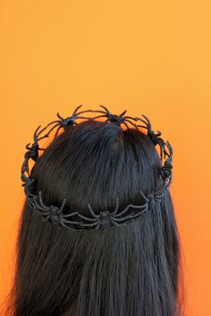 the back of a woman's head wearing a crown of braids on it