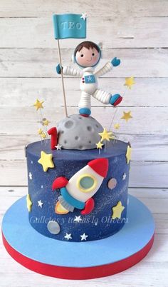 a birthday cake with an astronaut on top