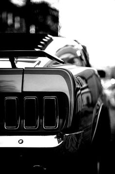 the front end of an orange sports car