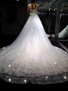 a woman in a wedding dress looking into a mirror