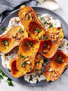 baked delicacy sweet potatoes on a plate topped with nuts and parmesan