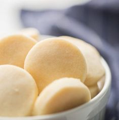 a close up of a bowl of food on a table with napkins in the background