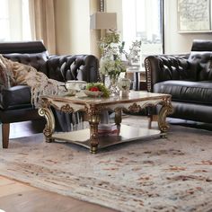 a living room with two couches, a coffee table and a rug on the floor