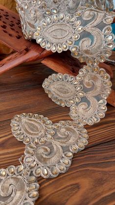 an image of decorative lace on wood flooring