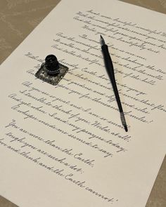 a fountain pen and ink sitting on top of a piece of paper