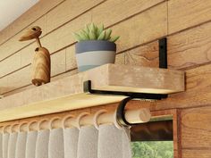 a shelf with some plants on it and a potted plant next to the window