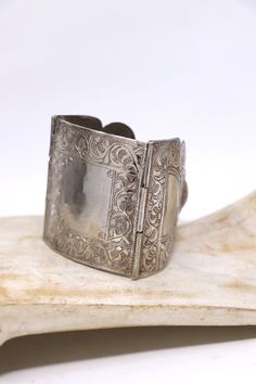 Beautiful vintage three panel silver bracelet. The panel are hand engraved on the surface.   large central panel size : 2 1/2 in x 2 1/4 in Length: 7.5 in roughly Weight: 75 grams Minor scratching on the surface .In overall good condition. Vintage Engraved Sterling Silver Bracelet In Antique Silver, Engraved Antique Silver Sterling Bracelet In Vintage Style, Victorian Etched Cuff Bracelet, Vintage Engraved Antique Silver Sterling Bracelet, Victorian Style Silver Engraved Bangle, Victorian Silver Engraved Bangle, Victorian Style Engraved Silver Bangle, Silver Stamped Cuff Bracelet For Wedding, Antique Silver Engraved Bracelets