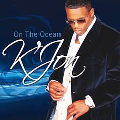 a man in a suit and sunglasses is looking down at his shirt with the words on the ocean written below him