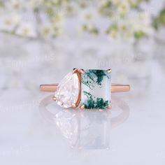 an engagement ring with a green and white stone