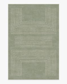 a green rug with white lines on the bottom and one line in the middle, against a light gray background