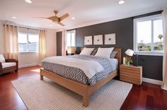 a bedroom with a large bed and wooden floors