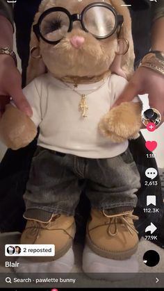 a person holding a stuffed animal with glasses on it's face and wearing shorts