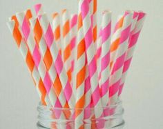 pink and orange striped paper straws in a mason jar with the words let's party creations