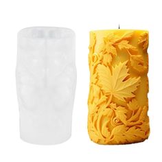 a candle that is sitting next to a vase with leaves on the inside of it