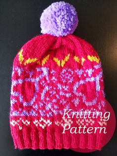 a knitted hat with a pom - pom sitting on top of it