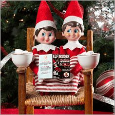 two elfs sitting on a chair with coffee cups