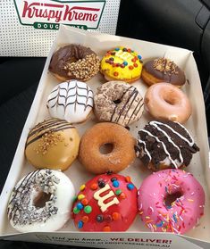 a box filled with lots of different flavored donuts