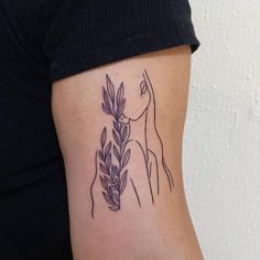 a woman's arm with a giraffe and leaves tattoo on the side