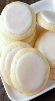 several cookies with white icing on a plate