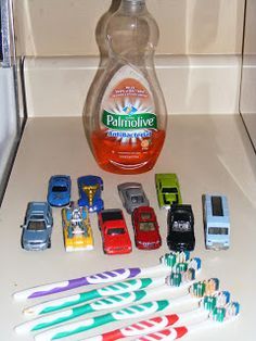 toothbrushes, mouthwash, and mouth sanitizer sitting on top of a counter