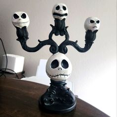 three jack - o'- lantern candlesticks are sitting on top of a table