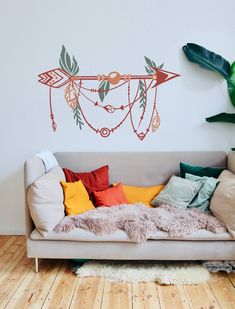 a living room with a couch, rug and wall decal