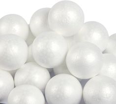 white plastic balls are piled on top of each other