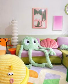 an octopus stuffed animal sitting on top of a green couch